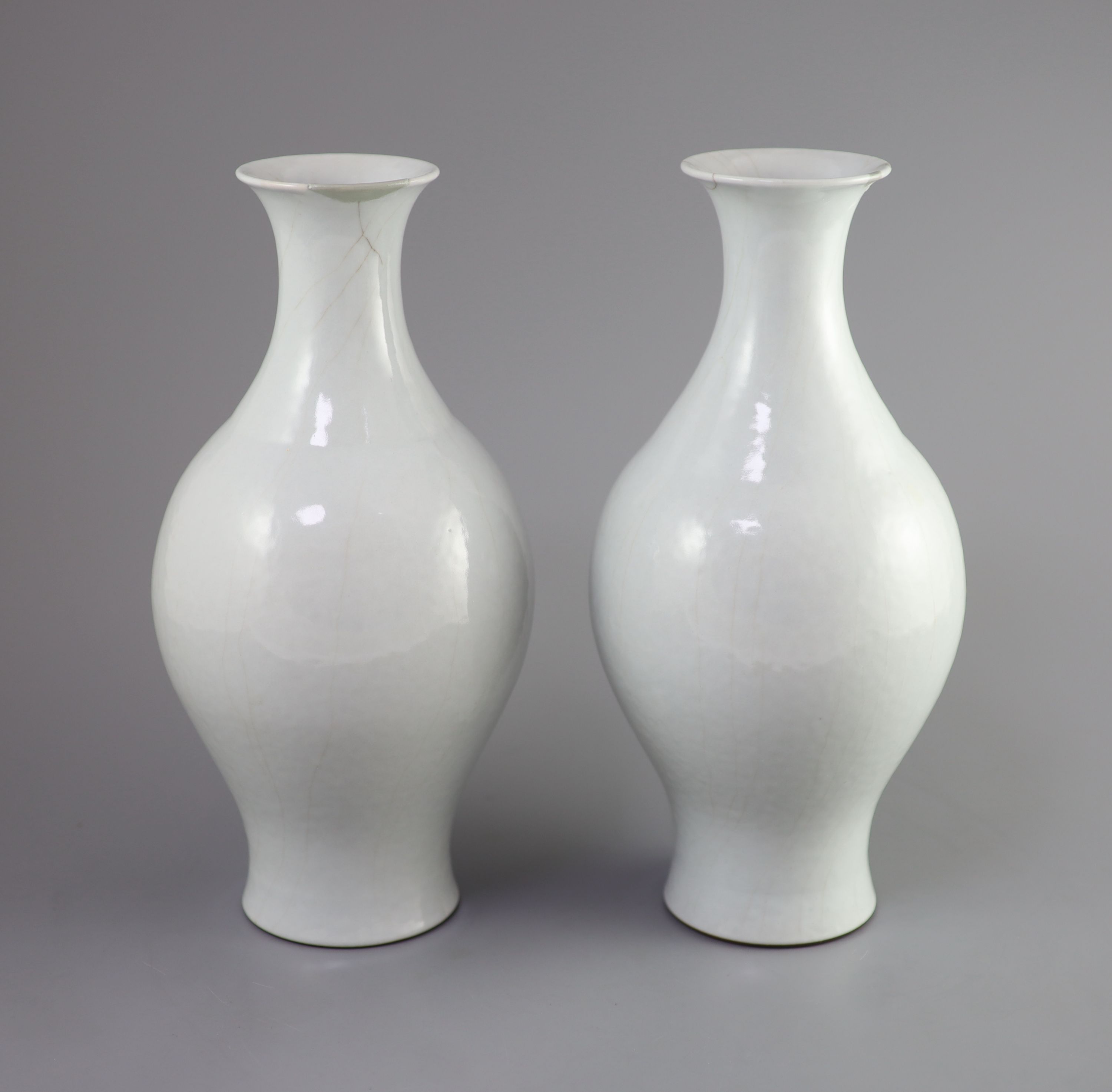 A pair of Chinese Guan-type vases, ganlan, Qianlong seal mark and possibly of the period, 31.5cm high, repairs